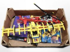 Two assembled LEGO aircraft and several LEGO assembly books.