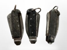 Three military issue jack knives.