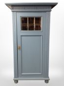 An early-20th century painted pine single-door cabinet with shelved interior,