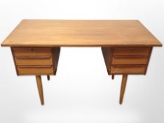 A 20th century Danish teak, pine and MDF twin pedestal desk fitted six drawers,