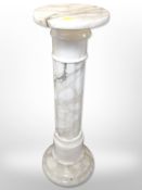 A white onyx pedestal,