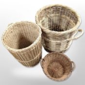 Three twin-handled wicker baskets, largest 50cm high.
