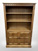An Ercol 'Golden Dawn' bookcase, width 97cm x 34cm deep x 154cm high.
