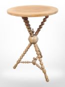 A 19th century oak bobbin turned tripod table,