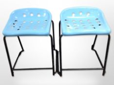 A pair of vintage metal framed stools with blue plastic seats