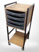 A vintage teak veneered office stand on castors,