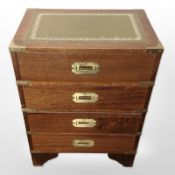 A campaign style mahogany and brass mounted four drawer low chest,