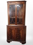 A reproduction mahogany corner cabinet,