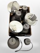 A group of seven contemporary industrial-style pendant light shades.