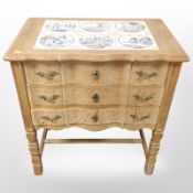 A Danish oak serpentine fronted oak chest with tile inset top,