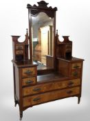 A late-Victorian Art Nouveau carved walnut sunk-centre dressing table with mirror back,