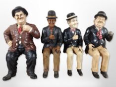 Four composition figures of Stan Laurel and Oliver Hardy in seated pose,