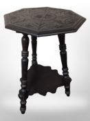 A Victorian carved and ebonised oak octagonal occasional table, height 71cm.