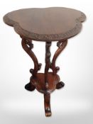 A reproduction carved mahogany tripod occasional table,
