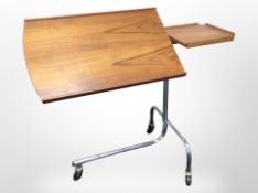A 20th-century Danish teak reading stand on chrome support raised on castors, height 76cm.