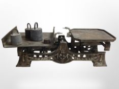 A 19th-century set of cast iron scales, with several weights.