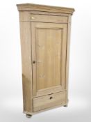 A 19th-century stripped pine corner cupboard, height 172cm.