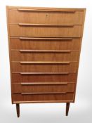 A 20th century Danish teak and pine eight drawer chest,
