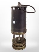 A 19th-century brass and steel miner's lamp.