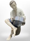 A Bing & Grøndahl figure of a boy playing an accordion, height 22cm.