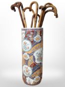 A Japanese export porcelain stick stand, containing walking sticks,