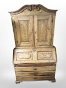 A 19th-century pine bureau bookcase, 120cm wide x 59cm deep x 215cm high.