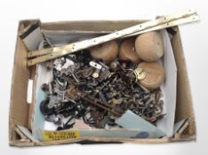 A quantity of door furniture including handles, escutcheons, set of four pine bun feet,