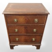 A reproduction mahogany three drawer chest,