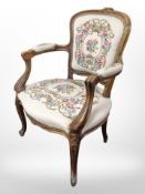 A continental carved beech salon armchair in tapestry fabric.