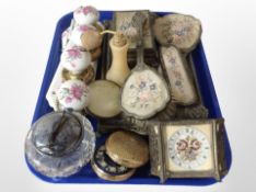 A group of petit point dressing table items, compacts, ceramic door handles and plaques, atomiser,