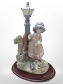 A Lladró figure, 'Fall Clean Up', No. 5286, on plinth, boxed.