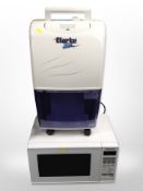 A Clark air dehumidifier and a Panasonic microwave.