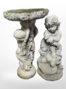 A concrete birdbath, height 63cm, and a further figure of a child.