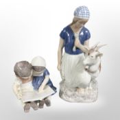A Bing & Grøndahl figure of a lady and a goat, and a further figure of two children reading,