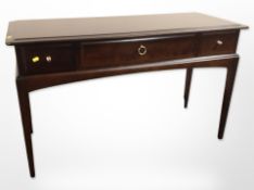 A Stag three drawer side table,