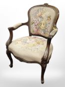 A continental carved beech salon armchair in tapestry fabric.