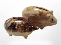 Two 20th-century slip-glazed pig money boxes, longest 18cm.