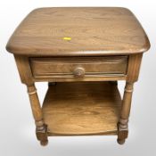 An Ercol 'Golden Dawn' lamp table, fitted with a drawer, 48cm wide x 44cm deep x 54cm high.