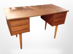 A 20th-century Danish teak, pine and ply twin-pedestal writing desk fitted six drawers,