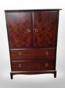 A Stag double-door cabinet fitted drawers beneath, 81cm wide x 46cm deep x 112cm high.