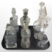 Nine continental glass decanters with stoppers.