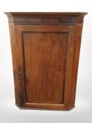 A George III oak corner cabinet,