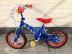 A child's bike, together with a Flymo garden vacuum and several tools.