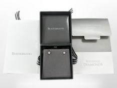 A pair of 9ct white gold diamond earrings, retailed by Beaverbrooks, with certificate stating 0.