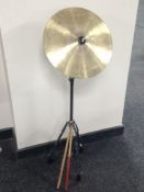 A pair of Nova drumsticks and a brass cymbal on chrome stand.