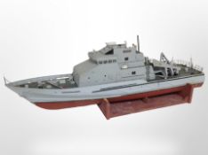 A scale model remote control boat marked 'Sentinel', on wooden stand, length 92cm.