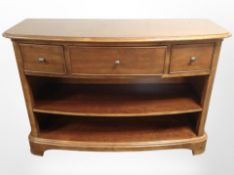 A Willis and Gambier three drawer sideboard fitted shelves beneath,