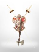 A pair of decorative swords on carved plaque,