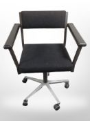 A metal framed swivel office armchair