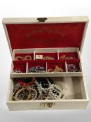 A contemporary jewellery box containing costume jewellery, faux pearls, bangles, etc.